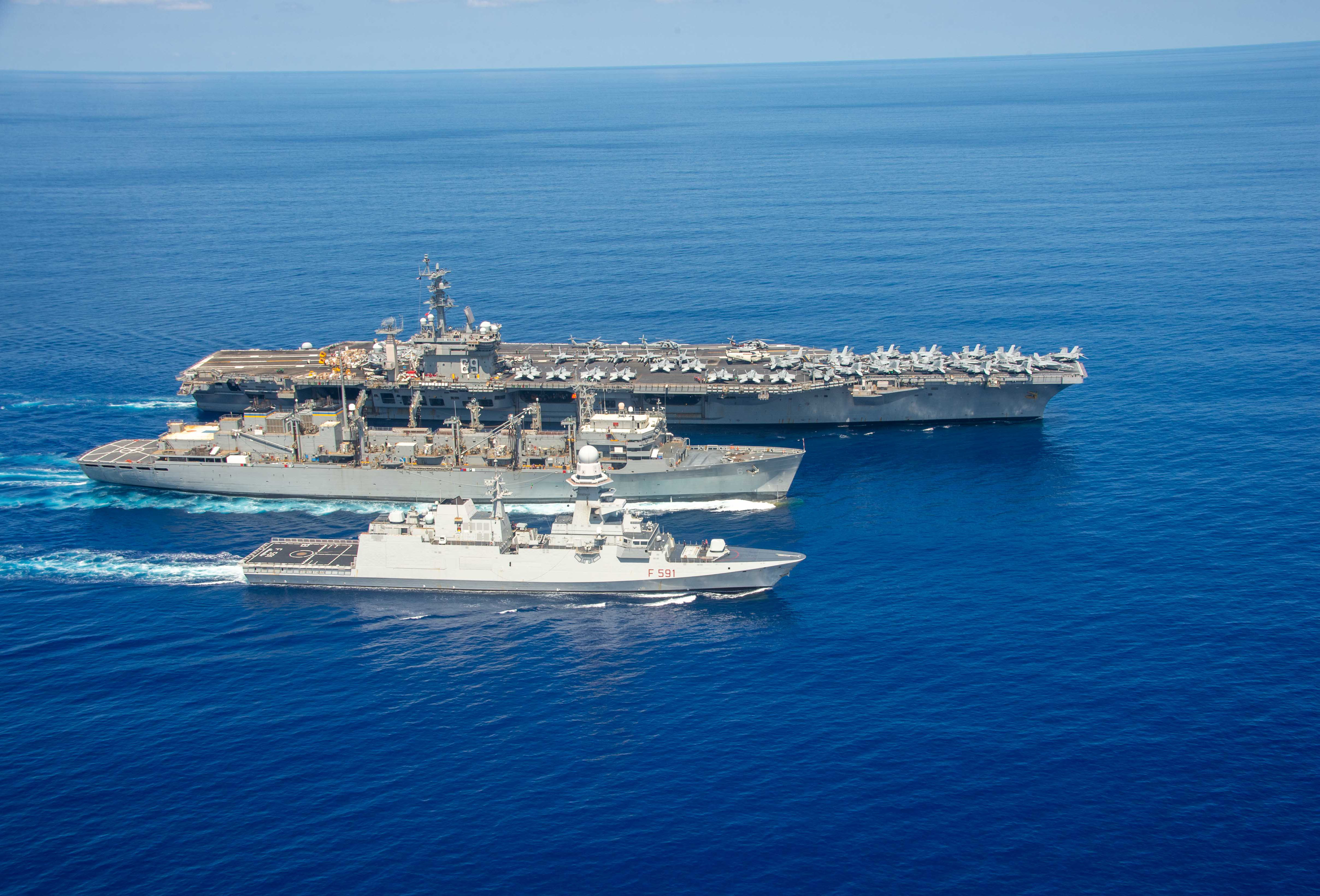 USS Dwight D. Eisenhower (CVN 69), top, USNS Supply (T-AOE 6) and the Italian navy frigate ITS Virginio Fasan (F 591) conduct a replenishment-at-sea in the Atlantic Ocean.