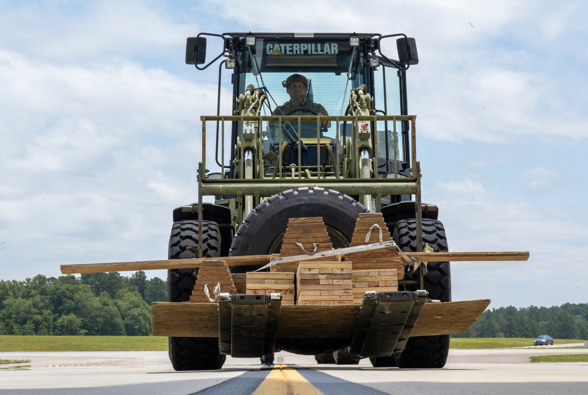 U.S. Air Force Staff Sgt. Jose Suarez, a 621st Mobility Support Operations Squadron enlisted air/ground liason element (EAGLE) team member, awaits orders to onload a C-17 Globemaster aircraft during Exercise SWAMP AVENGER at North Field, South Carolina, May 25, 2023.