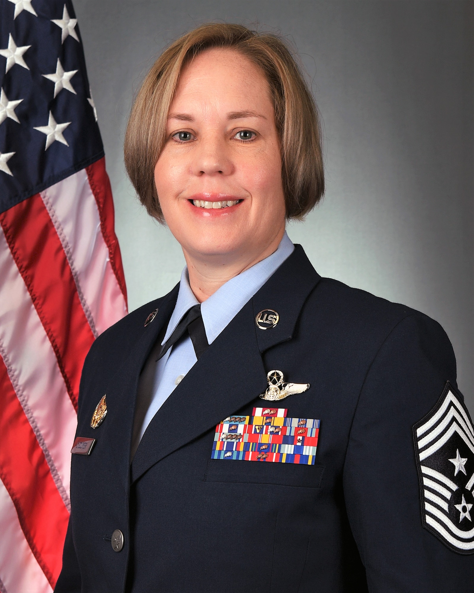 Official Air Force photo of command chief in front of U.S. flag