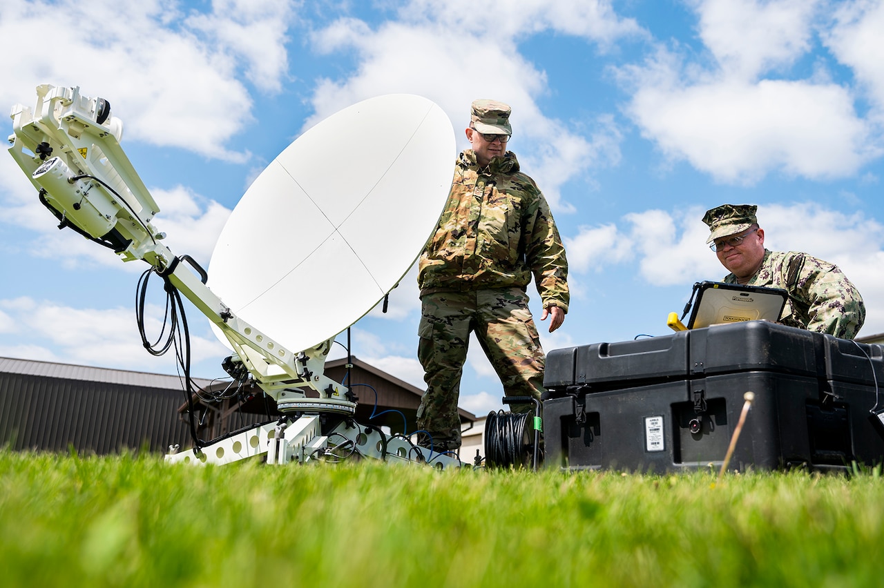 Troops work on a satellite.