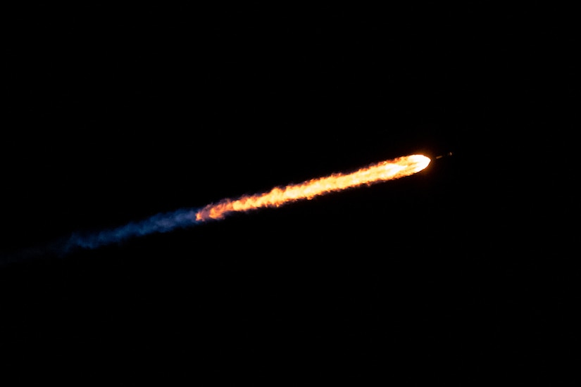 A rocket streaks through space.