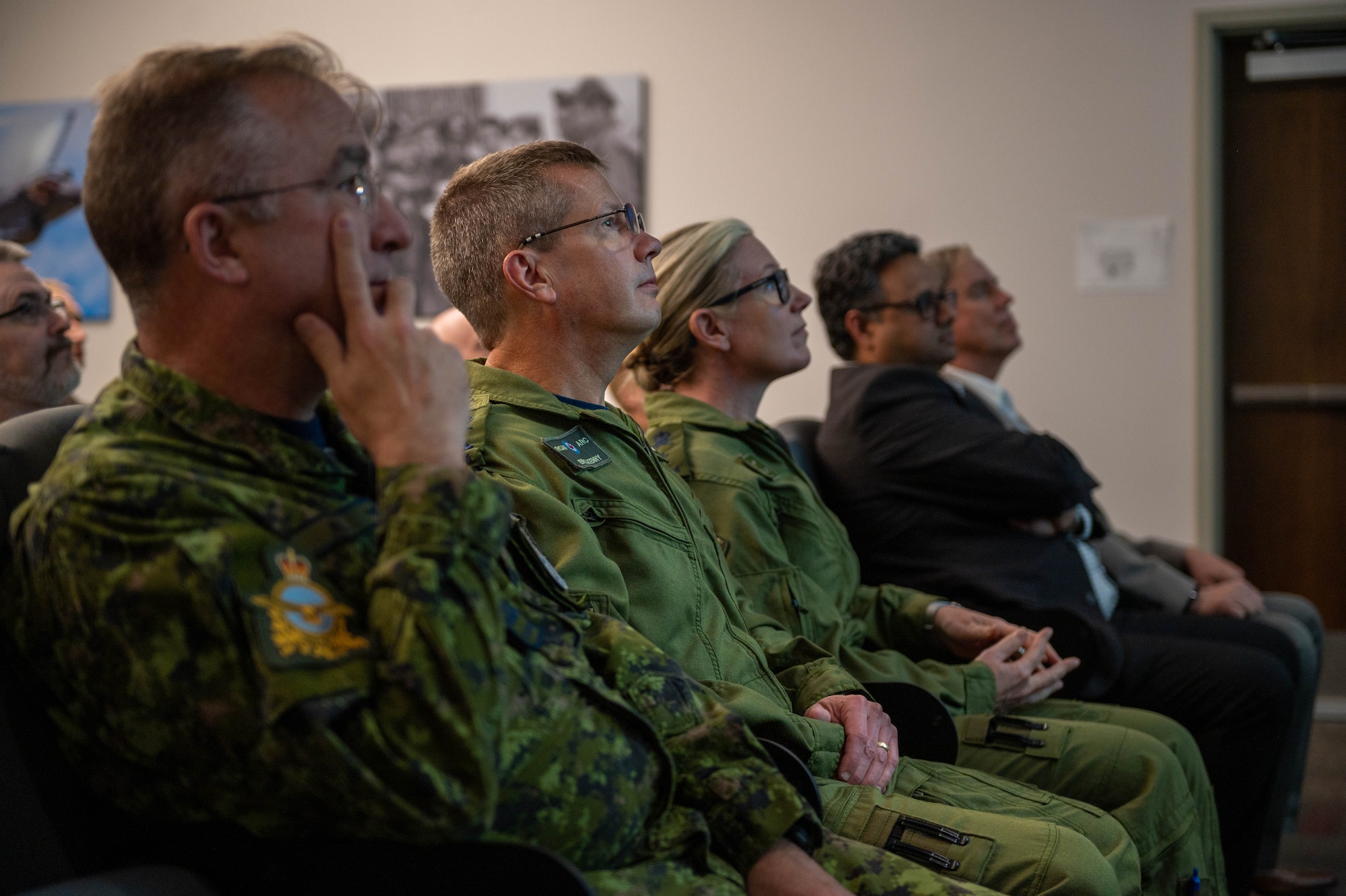 Royal Canadian Air Force Chief Warrant Officer John Hall, RCAF command chief warrant officer, RCAF Lt. Gen. Eric Kenny, RCAF commander, and RCAF Brig. Gen. Jamie Speiser-Blanchet, Cadets and Junior Canadian Rangers commanders, attend a mission brief for the 308th Fighter Squadron.