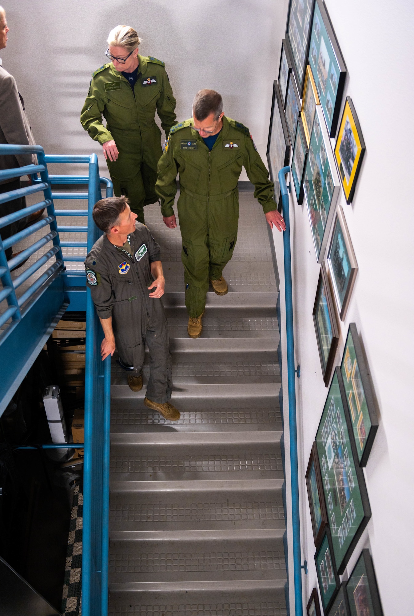 Royal Canadian Air Force Lt. Gen. Eric Kenny, RCAF commander, RCAF Brig. Gen. Jamie Speiser-Blanchet, Cadets and Junior Canadian Rangers commander, and U.S. Air Force Lt. Col. Brett Black, 308th Fighter Squadron commander, walk downstairs to the flightline.