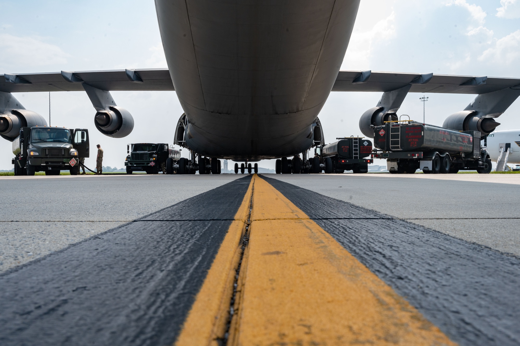 Team Dover takes part in a wet wing defuel on the flight line at Dover Air Force Base, Delaware, June 28, 2023. Airmen from the 9th Airlift Squadron and the 436th Logistics Readiness Squadron petroleum, oil and lubricant flight performed the first C-5M Super Galaxy wet wing defuel, utilizing four R-11 fuel trucks simultaneously. (U.S. Air Force photo by Airman 1st Class Dieondiere Jefferies)