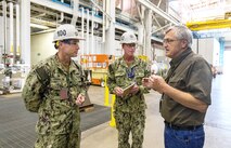 Capt. JD Crinklaw, left, commander, Puget Sound Naval Shipyard & Intermediate Maintenance Facility, and Cmdr. Brandon Johnson, PSNS & IMF executive officer, visit with Bill Schoonmaker, supervisor, Shop 31, Inside Machinist, June 27, 2023, during their tour of the San Diego Detachment. (U.S Navy Photo by Wendy Hallmark)