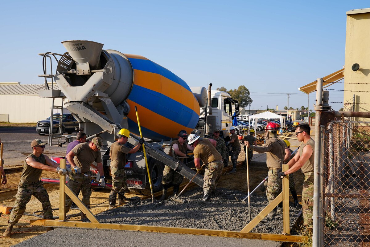 Members from the 152nd Civil Engineer Squadron, Nevada Air National Guard, pour concrete during construction of a pavement approach at Moron Air Base, Spain, June 26, 2023. The 152nd engineers were in Spain for Deployment For Training to increase readiness and expand skills.
