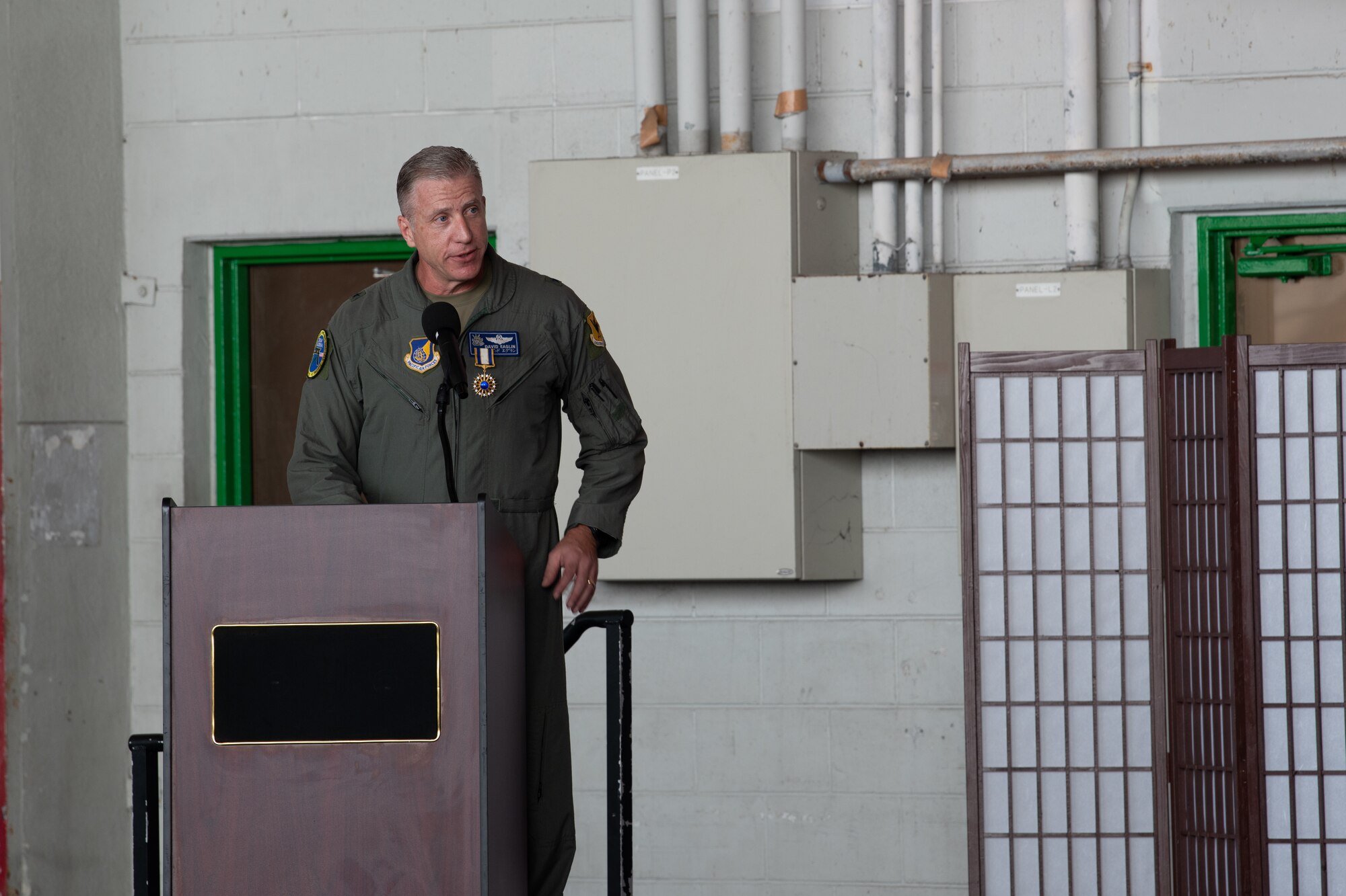 Man speaks at a podium.