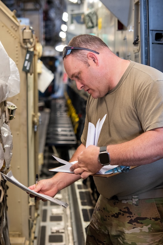 U.S. Air Force Tech. Sgt. Nicholas Stavropoulos, aerial port supervisor with the 123rd Contingency Response Element, 123rd Airlift Wing, Kentucky National Guard, manages cargo delivered in support of exercise Air Defender 2023 (AD23) at Wunstorf Air Base, Germany, June 4, 2023. Exercise AD23 integrates both U.S and allied air-power to defend shared values, while leveraging and strengthening vital partnerships to deter aggression around the world. (U.S. Air National Guard photo by Senior Master Sgt. Vicky Spesard)