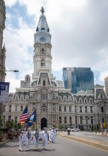 Sailors assigned to Navy Talent Acquisition Group Philadelphia, march past Philadelphia City Hall while participating in the Salute to America Independence Day Parade in Philadelphia.