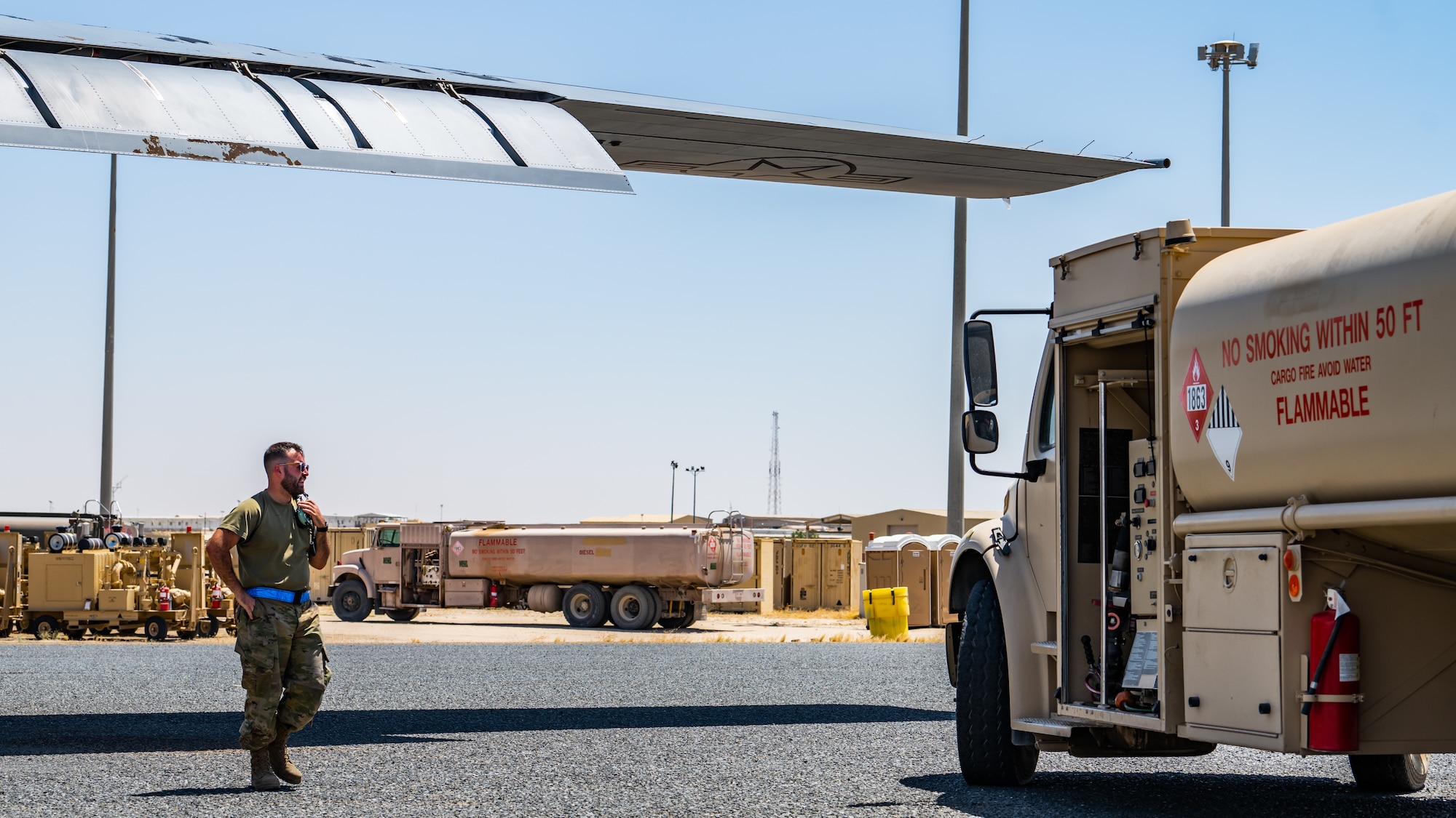 A C-130J Super Hercules crew chief assigned to the 386th Expeditionary Aircraft Maintenance Squadron directs a fuel truck into position before training with the 386th Expeditionary Logistics Readiness Squadron’s petroleum, oils and lubricants (POL) flight at Ali Al Salem Air Base, Kuwait, July 3, 2023. This training provided the opportunity for the 386th EAMXS to receive hands-on training from the POL flight so they are prepared to operate fuel trucks and service liquid nitrogen carts, thus furthering their abilities as Multi-Capable Airmen. (U.S. Air Force photo by Staff Sgt. Kevin Long)