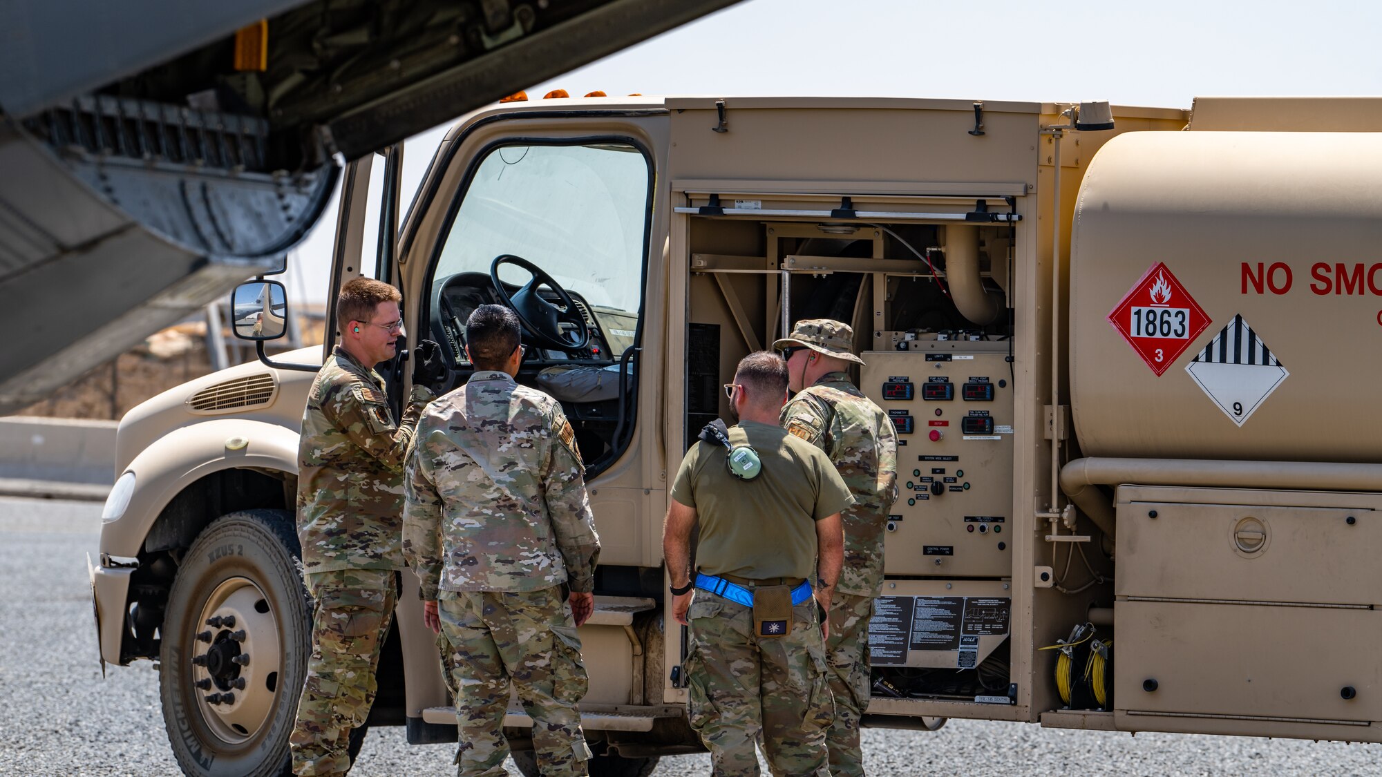 Airmen assigned to the 386th Expeditionary Aircraft Maintenance Squadron and the 386th Expeditionary Logistics Readiness Squadron’s petroleum, oils and lubricants (POL) flight discuss fuel truck operations and procedures during a training event at Ali Al Salem Air Base, Kuwait, July 3, 2023. Crew chiefs from the 386th EAMXS have teamed up with the 386th ELRS to learn how to use the fuel trucks and service liquid nitrogen carts in order to further their capabilities as Multi-Capable Airmen. (U.S. Air Force photo by Staff Sgt. Kevin Long)