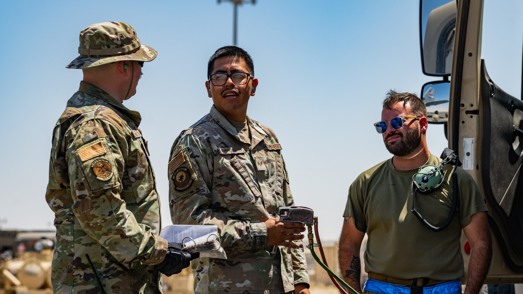 Airmen assigned to the 386th Expeditionary Aircraft Maintenance Squadron and the 386th Expeditionary Logistics Readiness Squadron’s petroleum, oils and lubricants (POL) flight discuss fuel truck operations and procedures during training at Ali Al Salem Air Base, Kuwait, July 3, 2023. As Multi-Capable Airmen, crew chiefs from the 386th EAMXS are now equipped with the knowledge to, if necessary, operate and service some of the on-the-ground fuel systems to help execute the mission. (U.S. Air Force photo by Staff Sgt. Kevin Long)