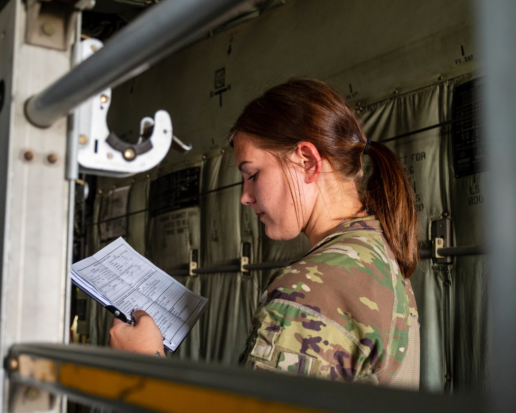 U.S. Air Force Staff Sgt. Ariel Kuhl, 405 Expeditionary Aeromedical Evacuation Squadron mission clinical coordinator (MCC), reviews a checklist during a combined 405 Expeditionary Aeromedical Evacuation Squadron (EAES), and 379 EAES Critical Care Air Transport Team (CCATT) training at Ali Al Salem Air Base, Kuwait, June 29, 2023.