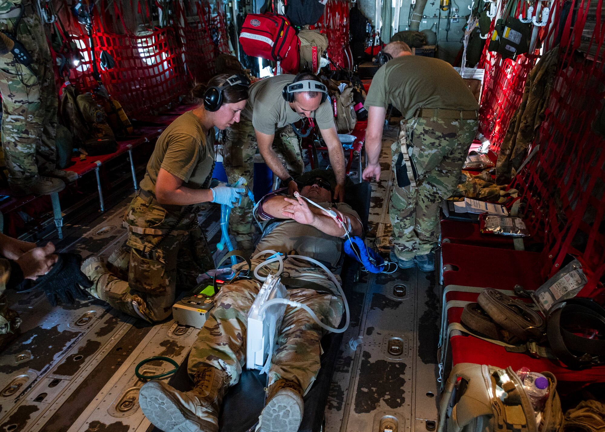 From left, U.S. Air Force Tech. Sgt. Devon Theis, Critical Care Air Transport Team (CCATT) respiratory technician, Maj. Andrew Hersh, CCATT Doctor, and Lt. Col. Stephen Murphy, CCATT registered nurse, perform patient care on a simulated intubated patient, during a combined 405 Expeditionary Aeromedical Evacuation Squadron (EAES), and 379 EAES CCATT training at Ali Al Salem Air Base, Kuwait, June 29, 2023.