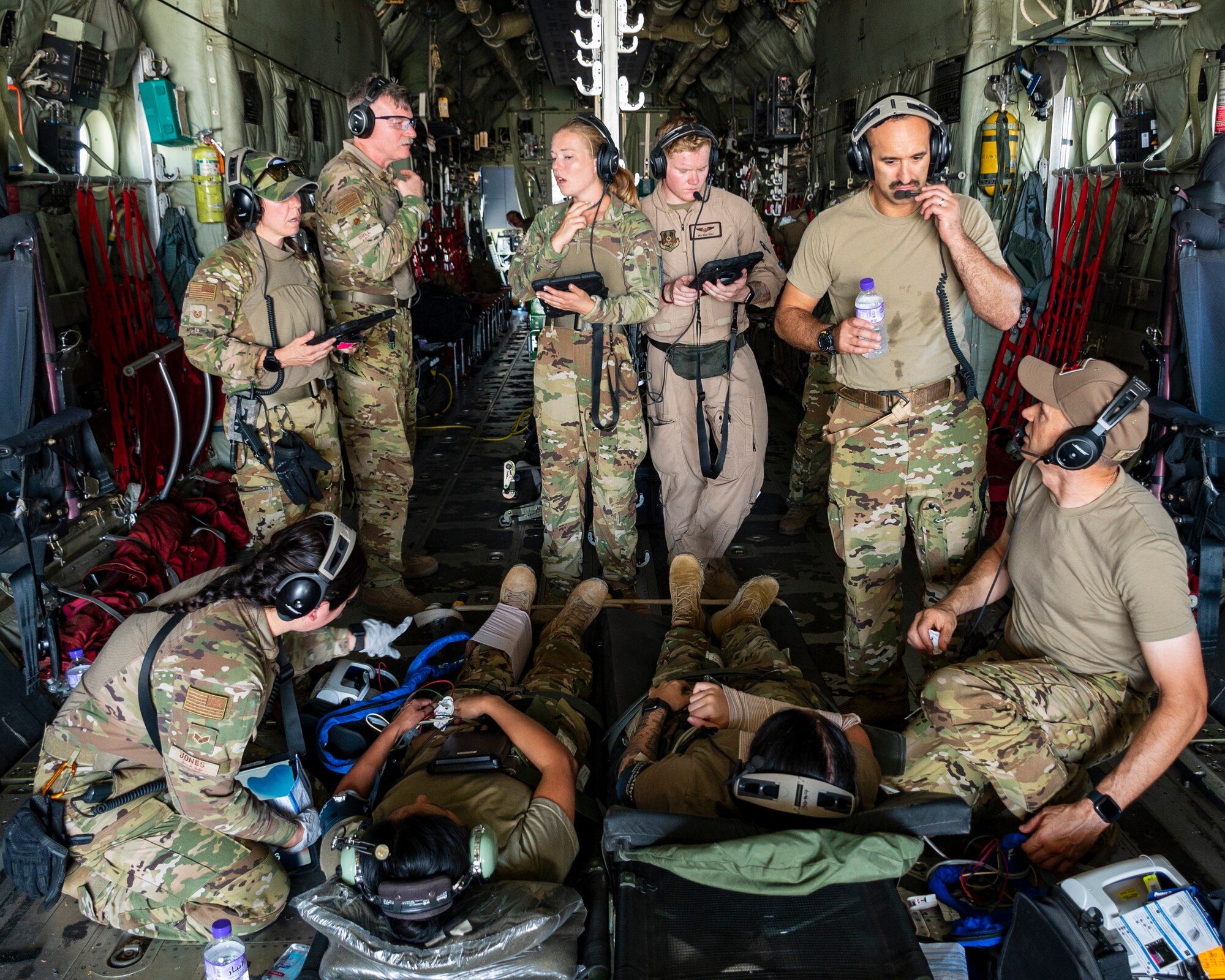 Members from the 405 Expeditionary Aeromedical Evacuation Squadron (EAES, AE), and the 379 EAES Critical Care Air Transport Team (CCATT), from Al Udeid Air Base, Qatar, practice patient emergency procedures following a simulated aircraft in-flight emergency, at Ali Al Salem Air Base, Kuwait, June 29, 2023.