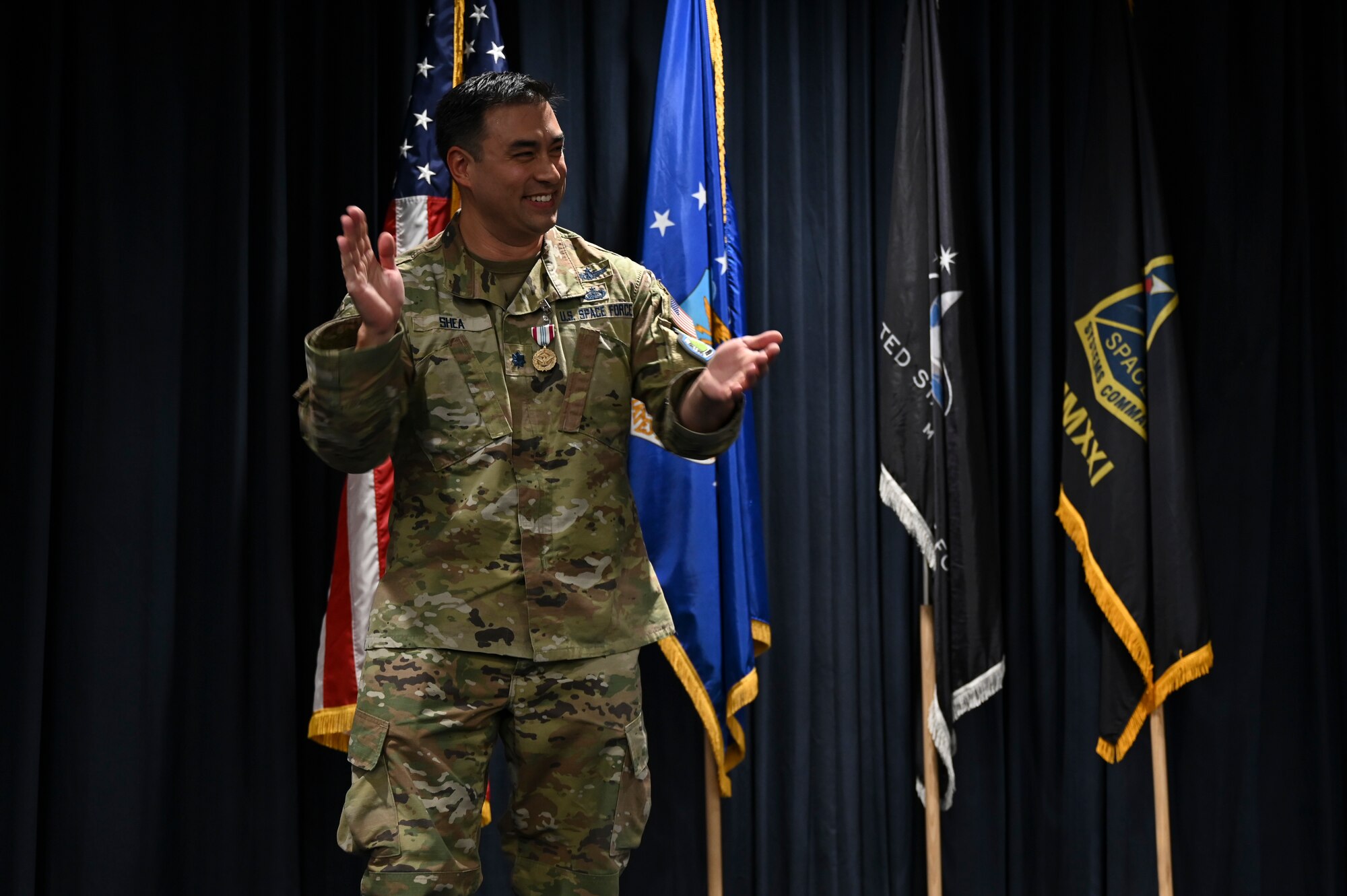 A man claps on stage.