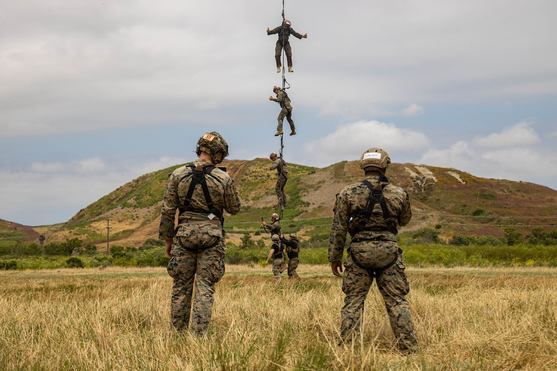U.S. Marines with 1st Reconnaissance Battalion, 1st Marine Division, 4th Reconnaissance Battalion, 4th Marine Division, and 1st Air Naval Gunfire Liaison Company, I Marine Expeditionary Force Information Group, conduct special patrol insert extraction operations out of a UH-1Y Venom during a helicopter rope suspension techniques course hosted by Expeditionary Operations Training Group, I MEF, at Marine Corps Base Camp Pendleton, California, June 13, 2023. The helicopter rope suspension techniques course creates HRST masters which are capable of supporting fast rope, rappel, and special patrol insertion/extraction operations from any U.S. Marine Corps helicopter and tiltrotor aircraft as a means to insert and extract ground forces into or from rough terrain and urban areas. (U.S. Marine Corps photo by Cpl. Gurule)