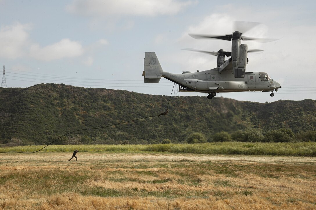 U.S. Marines with 1st Reconnaissance Battalion, 1st Marine Division, 4th Reconnaissance Battalion, 4th Marine Division, and 1st Air Naval Gunfire Liaison Company, I Marine Expeditionary Force Information Group, fast rope out of an MV-22 Osprey during a helicopter rope suspension techniques course hosted by Expeditionary Operations Training Group, I MEF, at Marine Corps Base Camp Pendleton, California, June 14, 2023. The helicopter rope suspension techniques course creates HRST masters which are capable of supporting fast rope, rappel, and special patrol insertion/extraction operations from any U.S. Marine Corps helicopter and tiltrotor aircraft as a means to insert and extract ground forces into or from rough terrain and urban areas. (U.S. Marine Corps photo by Cpl.Gurule)