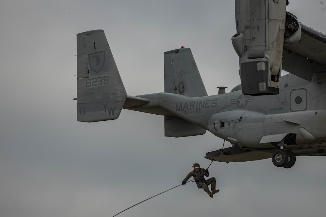 U.S. Marines with 1st Reconnaissance Battalion, 1st Marine Division, 4th Reconnaissance Battalion, 4th Marine Division, and 1st Air Naval Gunfire Liaison Company, I Marine Expeditionary Force Information Group, rappel out of an MV-22 Osprey during a helicopter rope suspension techniques course hosted by Expeditionary Operations Training Group, I MEF, at Marine Corps Base Camp Pendleton, California, June 14, 2023. The helicopter rope suspension techniques course creates HRST masters which are capable of supporting fast rope, rappel, and special patrol insertion/extraction operations from any U.S. Marine Corps helicopter and tiltrotor aircraft as a means to insert and extract ground forces into or from rough terrain and urban areas. (U.S. Marine Corps photo by Cpl. Gurule)