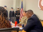 men and women sit at conference table