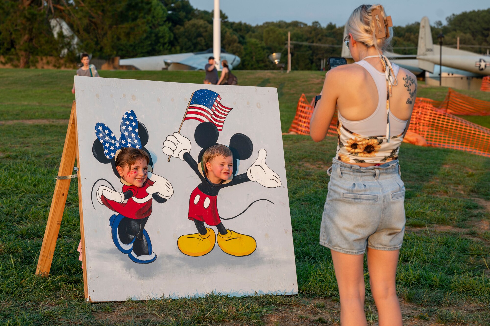 a woman takes a photo of her kids