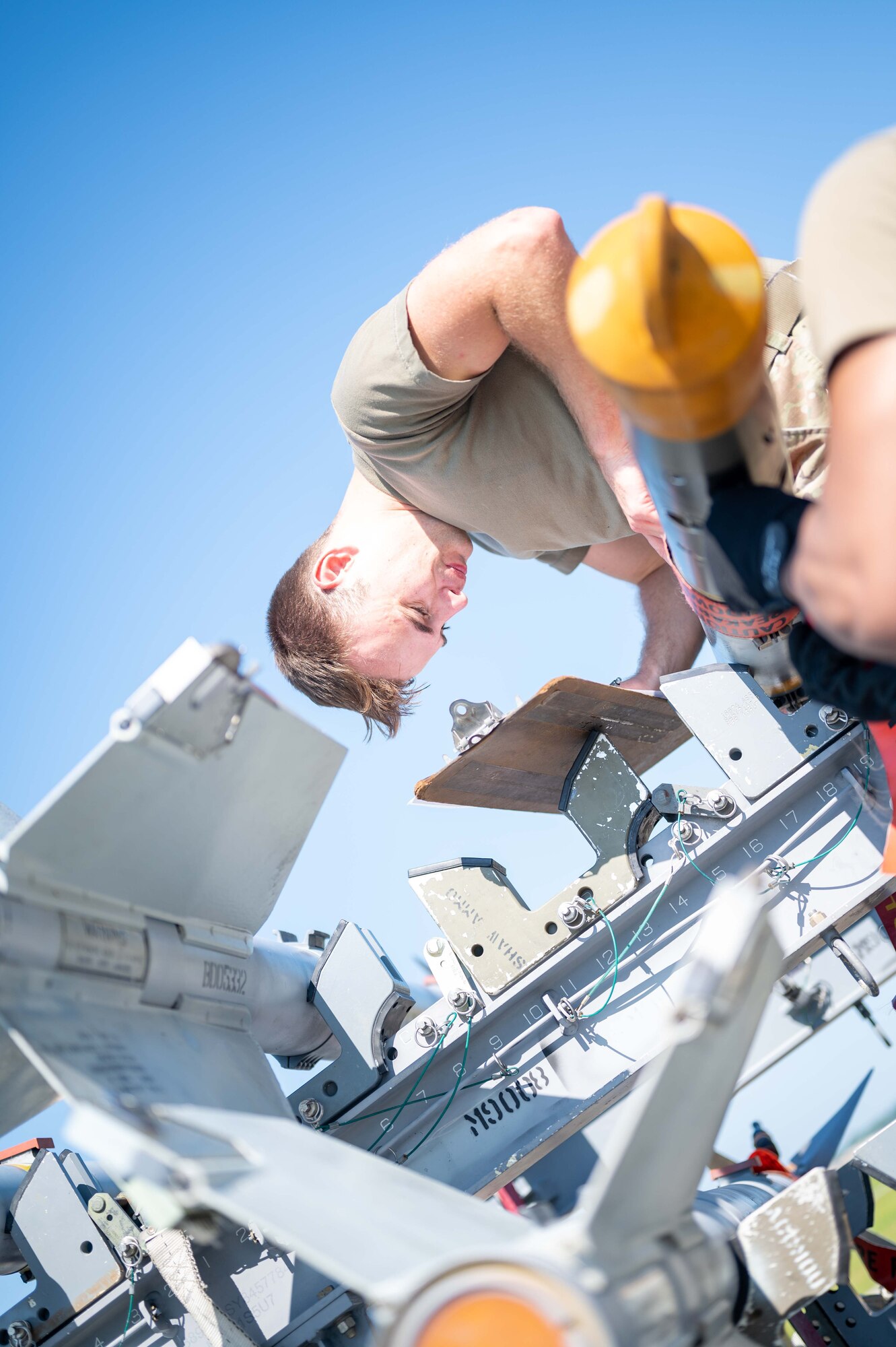 An Airman inspects the hardware of the missiles.