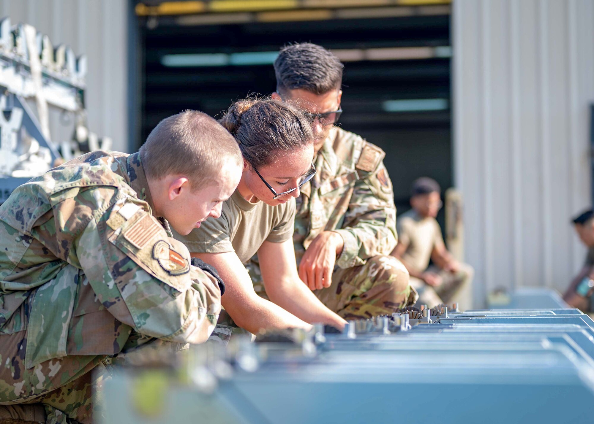 Airman unpack a missile from storage.