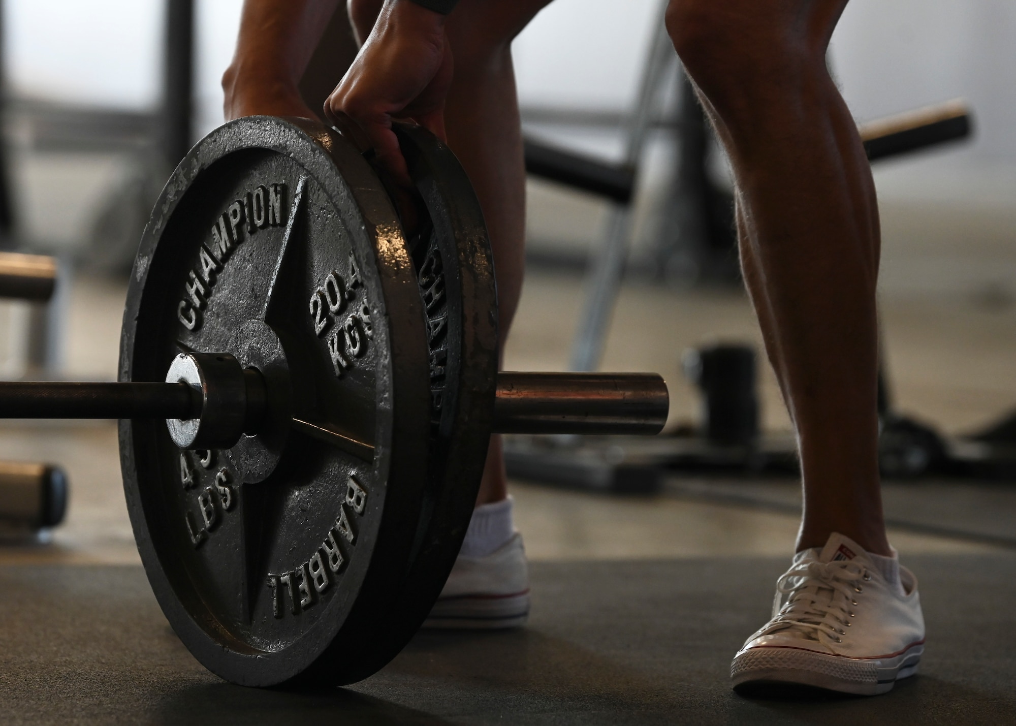 U.S. Air Force Tech. Sgt. Rory Caplan, NCO in charge of ramp services with the 62d Aerial Port Squadron, adds weighted plates to a barbell during a Warrior Heart Focus Day at Joint Base Lewis-McChord, Washington, June 28, 2023. The 62d APS hosted resiliency events, focused on building the best versions of their Airmen. The events included classes for diet and nutritional cooking, crossfit and weight training, sleep and fatigue support, stress management, spiritual resiliency, physical therapy, mindfulness and a running clinic. (U.S. Air Force photo by Senior Airman Callie Norton)