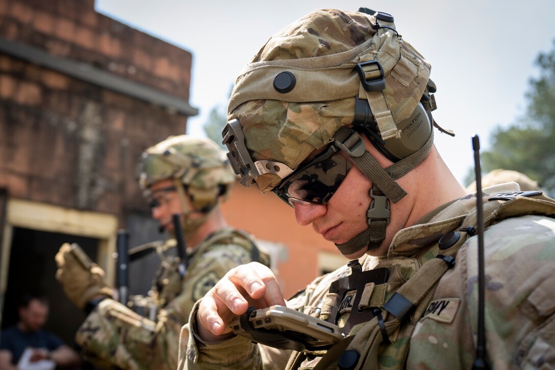 Soldiers check their Nett Warrior End User Devices during an Army Expeditionary Warrior Experiment (AEWE) force-on-force field demonstration