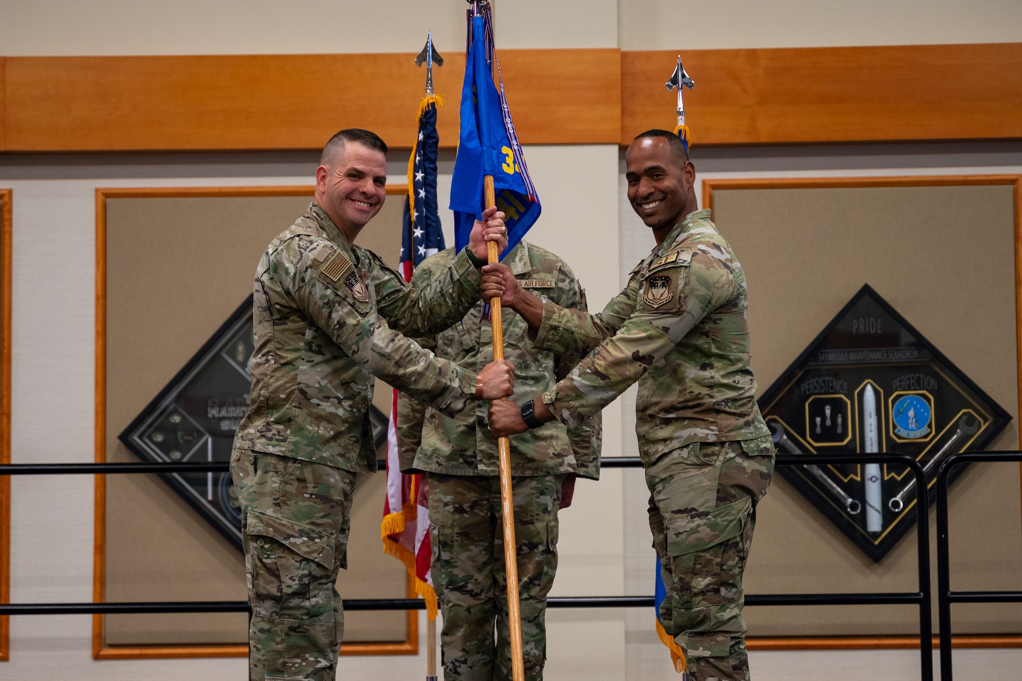 Two men holding a flag.