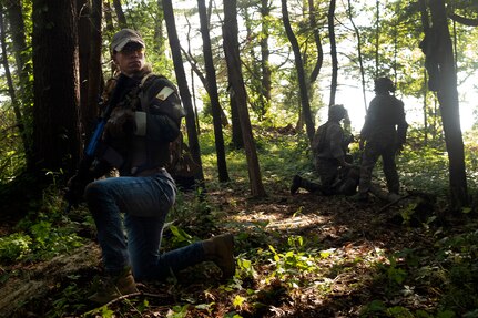 Soldiers with the 19th Special Forces Group, headquartered in the Utah Army National Guard, assess a potential ambush site as a member of a partner force provides security during exercise Ridge Runner in Beckley, West Virginia, June 13, 2023. The two-week exercise brought together Soldiers with the 19th SFG and special operations troops from Latvia, Poland and other allied and partner nations and focused on interoperability in unconventional warfare tasks. (