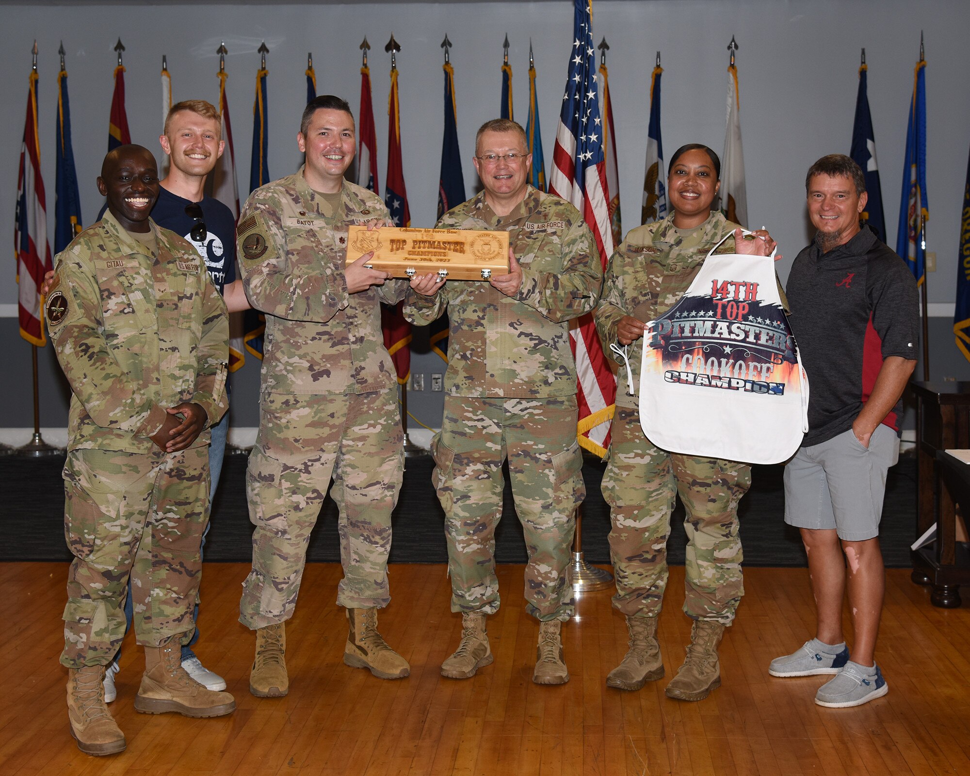 Winners of the Top Pitmaster cook-off stand with prize.