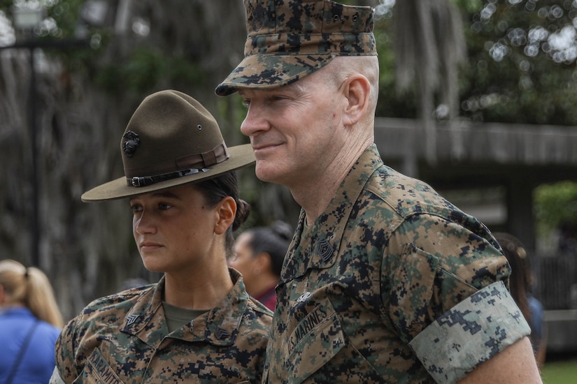 Two Marines stand together.