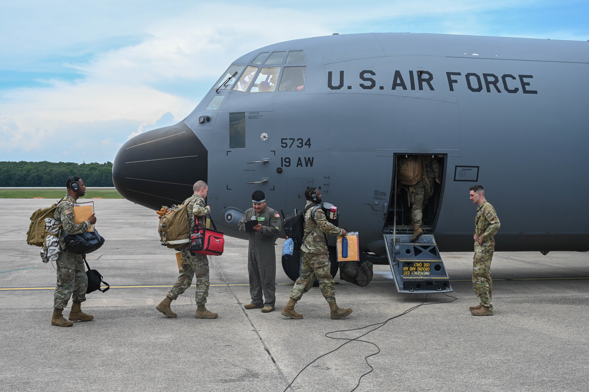 Airmen load onto a C-130J Super Hercules to head to an exercise
