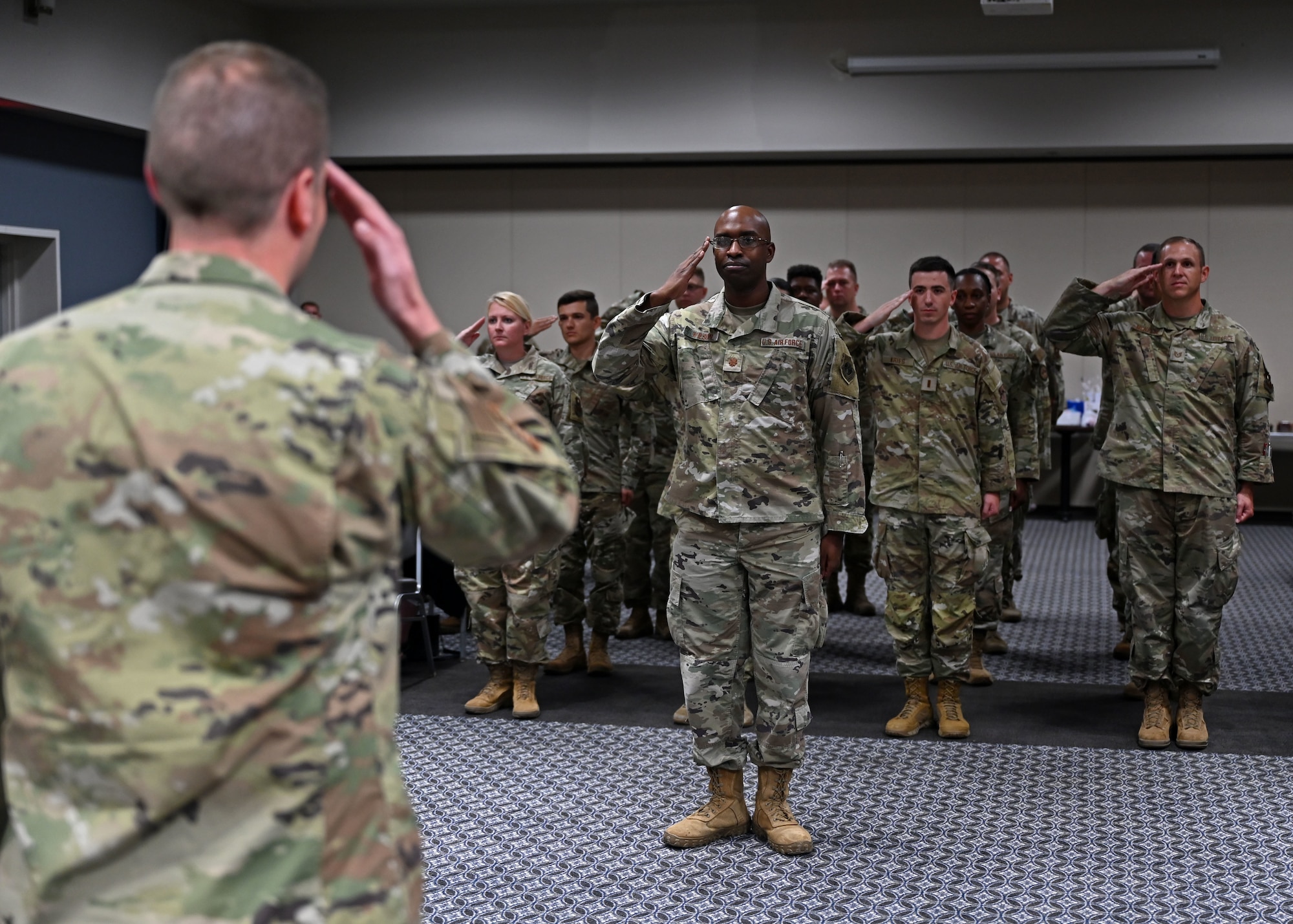 U.S. Air Force Airmen assigned to the 315th Training Squadron present Lt. Col. Richard Ball, 315th TRS commander, at the Powell Event Center, Goodfellow Air Force Base, Texas, July 6, 2023. The salute represents the squadron welcoming their new commander. (U.S. Air Force photo by Senior Airman Sarah Williams)