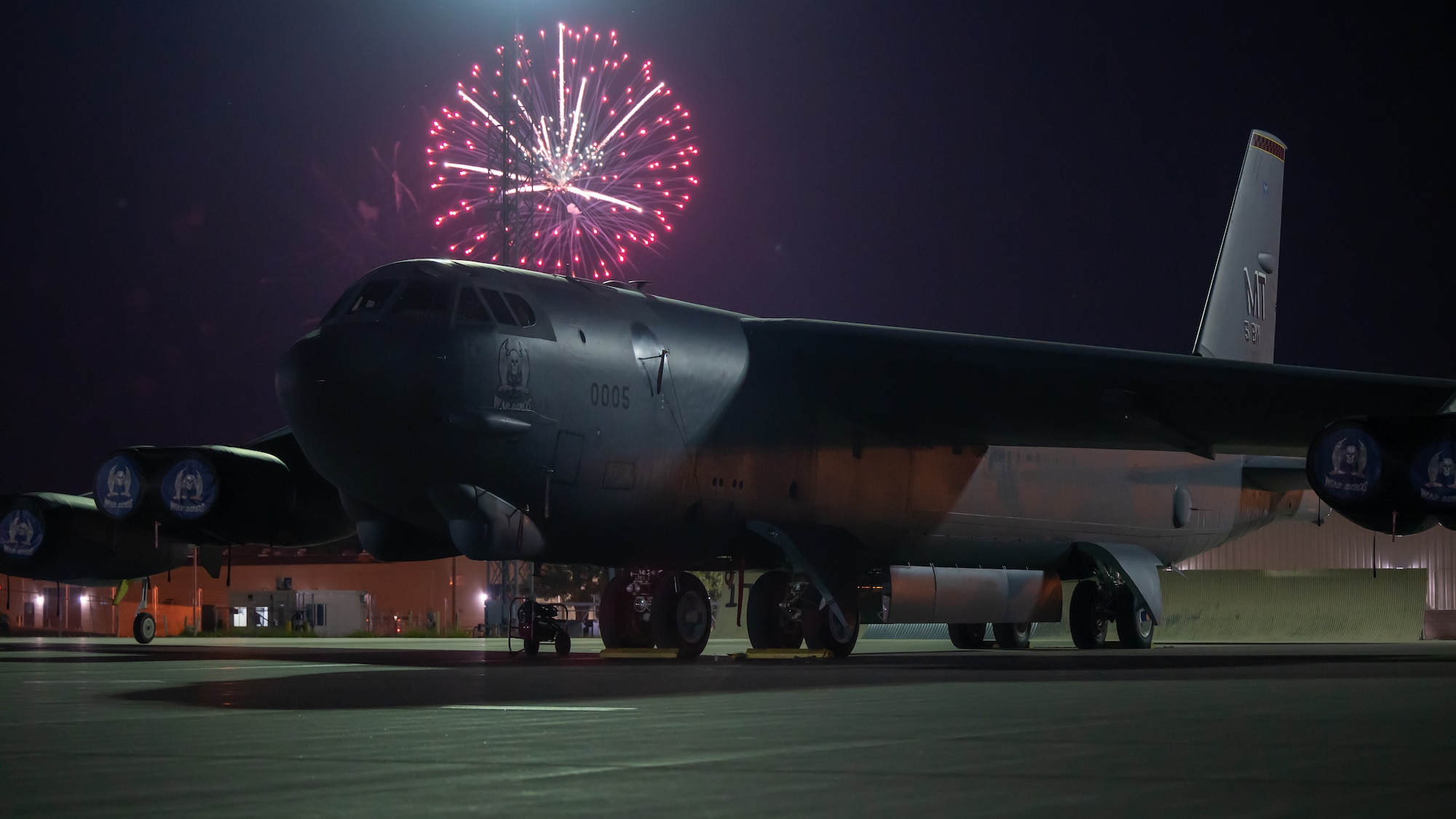 A B52-H Stratofortress assigned to the 23rd Bomb Squadron sits on the main parking apron during a firework display at Minot Air Force Base, North Dakota, June 30, 2023. The firework show was the final event for Freedom Fest put on by the 5th Force Support Squadron celebrating freedom. (U.S. Air Force photo by Airman 1st Class Alexander Nottingham)