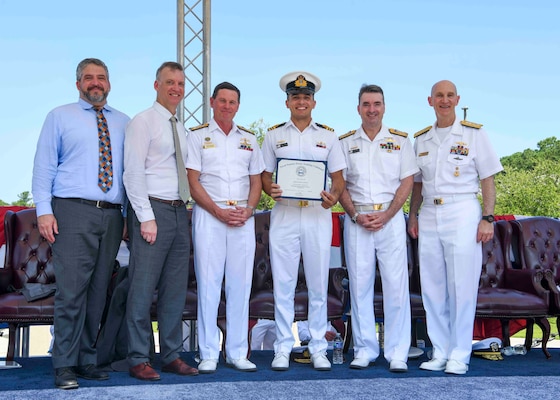 Adm. James F. Caldwell Jr., director, Naval Nuclear Propulsion Program, right, Royal Australian Navy Vice Adm. Jonathan Mead, director-general of the Australian Submarine Agency, Royal Australian Navy Lt. Cmdr James Heydon, Royal Australian Navy Vice Adm. Mark Hammond, Chief of Navy, the Honorable Erik Raven, Under Secretary of the Navy, and Abraham M. Denmark, Senior Advisor to the Secretary of Defense for AUKUS, pose for a photo during a United States Naval Nuclear Power School (NPS) graduation ceremony at Naval Nuclear Power Training Command (NNPTC), July 7, 2023. Three Royal Australian Navy (RAN) officers graduated NPS, marking a significant step in Australia's goal to operate conventionally-armed, nuclear-powered attack submarines (SSNs). (U.S. Navy photo by Mass Communication Specialist 2nd Class Dart D. De La Garza)