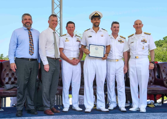 Adm. James F. Caldwell Jr., director, Naval Nuclear Propulsion Program, right, Royal Australian Navy Vice Adm. Jonathan Mead, director-general of the Australian Submarine Agency, Royal Australian Navy Lt. Cmdr Adam Klyne, Royal Australian Navy Vice Adm. Mark Hammond, Chief of Navy, the Honorable Erik Raven, Under Secretary of the Navy, and Abraham M. Denmark, Senior Advisor to the Secretary of Defense for AUKUS, pose for a photo during a United States Naval Nuclear Power School (NPS) graduation ceremony at Naval Nuclear Power Training Command (NNPTC), July 7, 2023. Three Royal Australian Navy (RAN) officers graduated NPS, marking a significant step in Australia's goal to operate conventionally-armed, nuclear-powered attack submarines (SSNs). (U.S. Navy photo by Mass Communication Specialist 2nd Class Dart D. De La Garza)