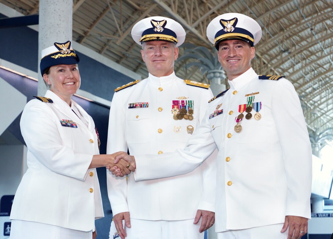 Rear Adm. Douglas M. Schofield, commander of the Seventh Coast Guard District, Cmdr. Sarah Brennan, the Marine Safety Unit Port Canaveral Commander, and Lt. Cmdr. John Di Nino, the former MSU Port Canaveral Commander, pose for a photo during a Change of Command ceremony at Port Canaveral, Florida, July 7, 2023. During the ceremony, Brennan relieved Di Nino as the MSU Port Canaveral Commander. (U.S. Coast Guard photo by Coast Guard Auxiliary member Jill Bazeley)