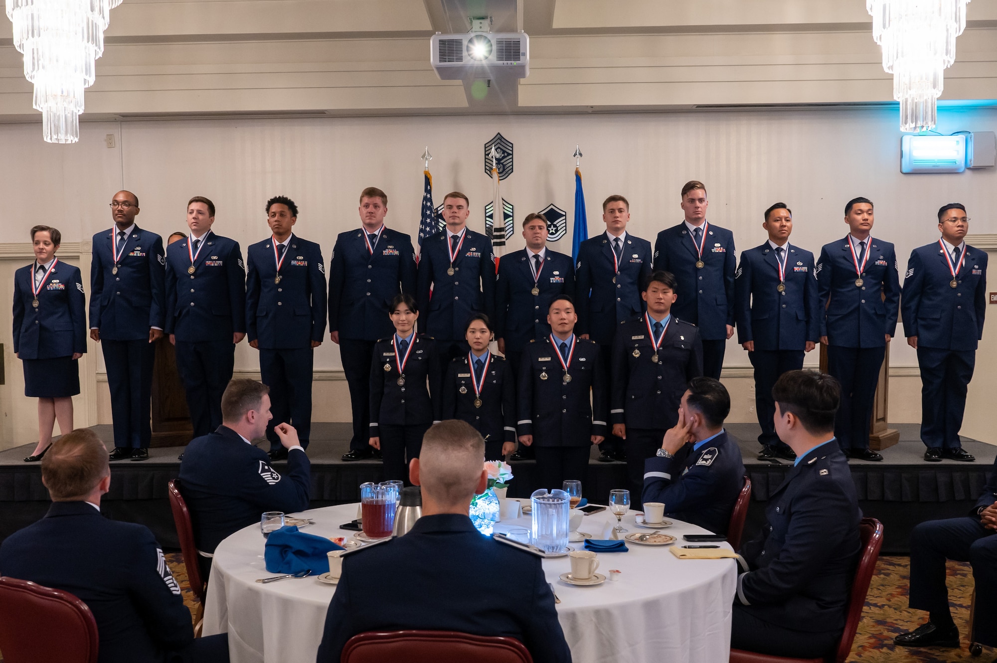 Airman Leadership School Class 23-B sings the U.S. Air Force song during their graduation ceremony at Kunsan Air Base
