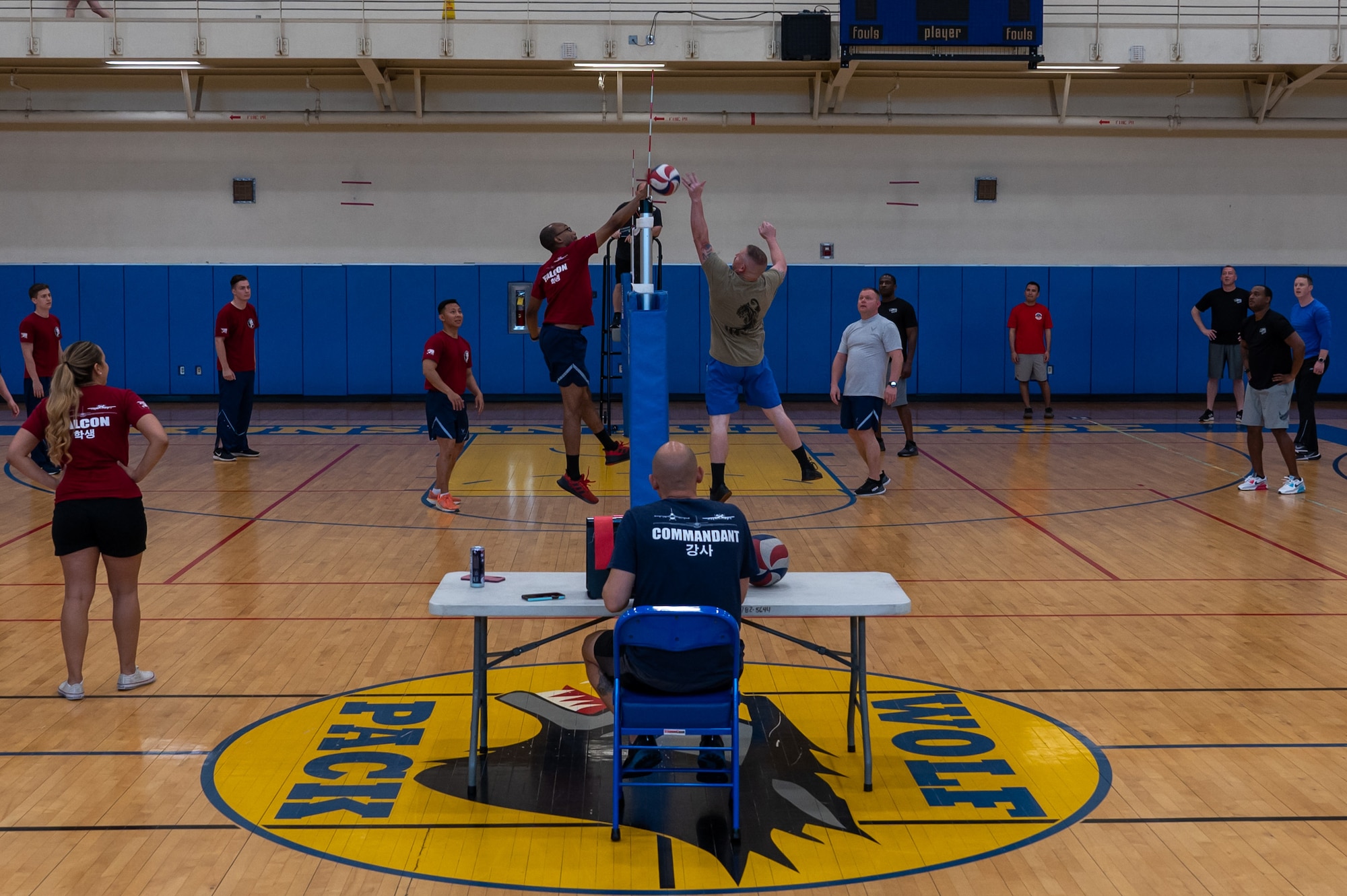 Senior Airman Adam Hairston and Chief Master Sgt. Josh Vanderbeck meet at the net during a volleyball match at Kunsan Air Base