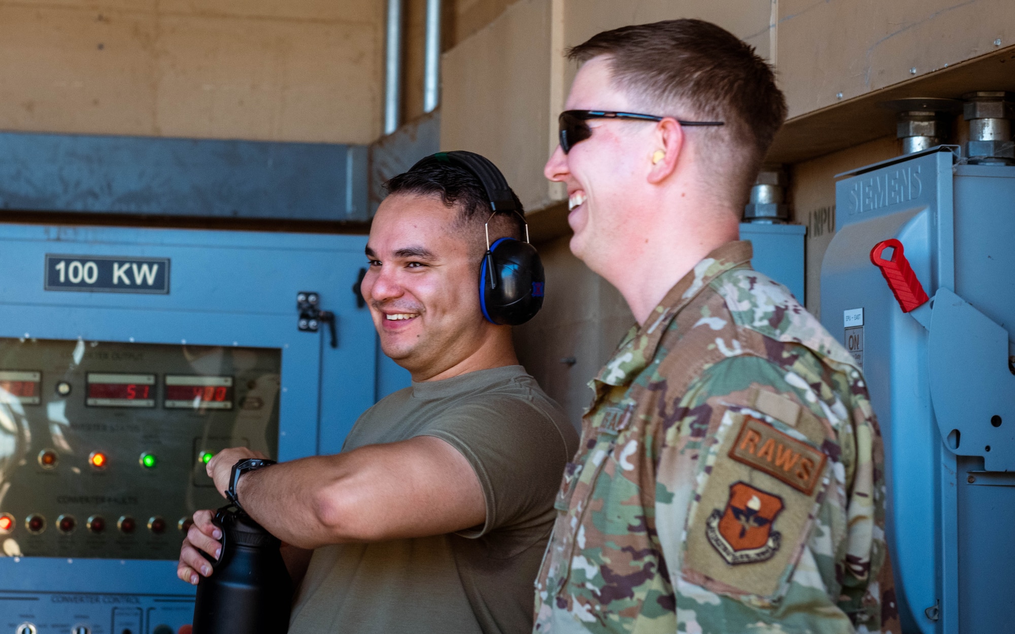 U.S. Air Force Staff Sgt. Juan Cervantes (left), 607th Air Control Squadron ground radar systems supervisor, and U.S. Air Force Staff Sgt. Kyle Tidwell (right), 607th Air Control Squadron noncommissioned officer in charge of ground radar systems, observe operators in a bunker, June 28, 2023, at Luke Air Force Base, Arizona.