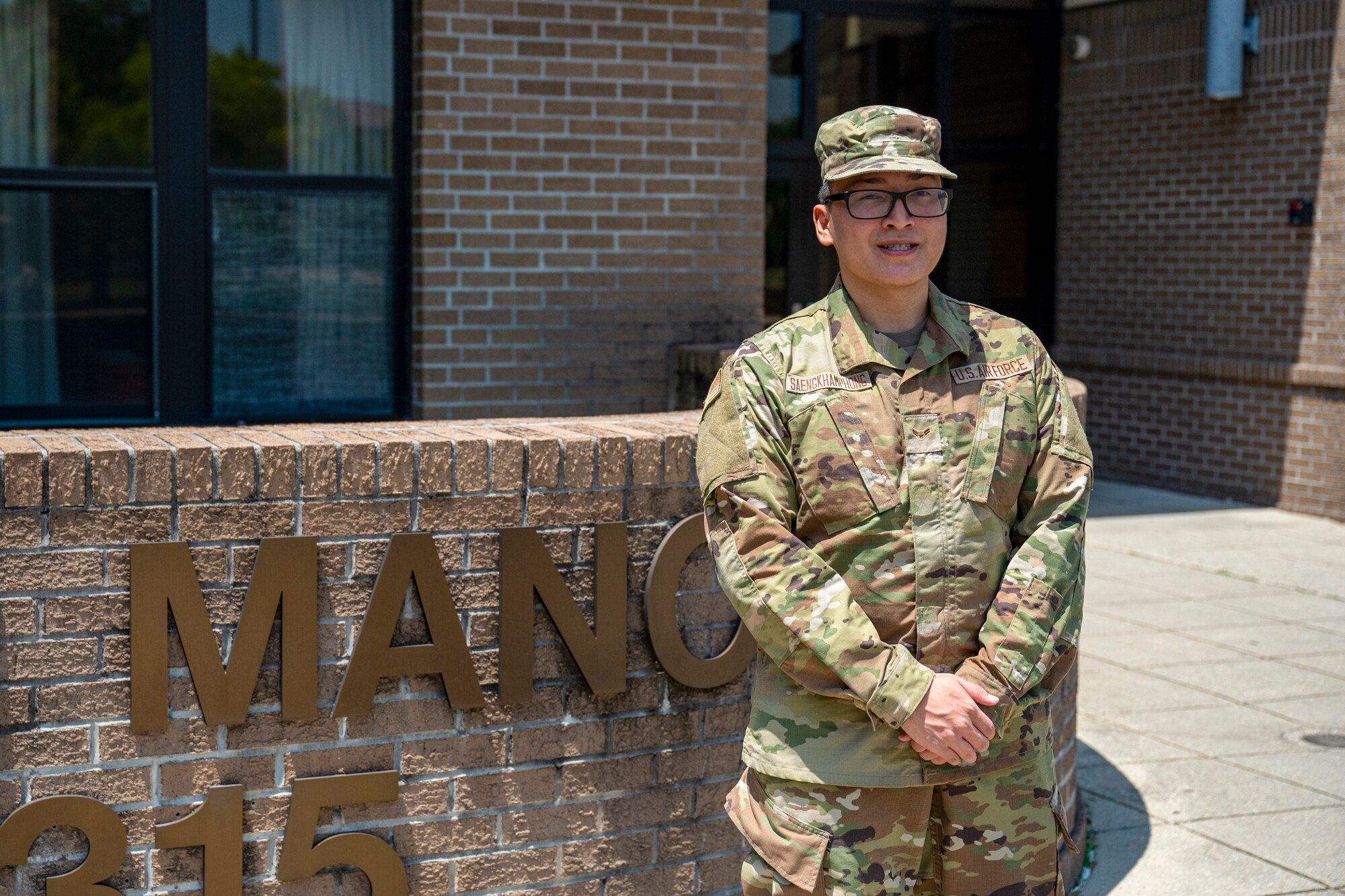 U.S. Air Force Airman 1st Class Poodthaneth Saengkhamphong, 336th Training Squadron knowledge operations course graduate, poses in front of Smith Manor at Keesler Air Force Base, Mississippi, June 16, 2023.