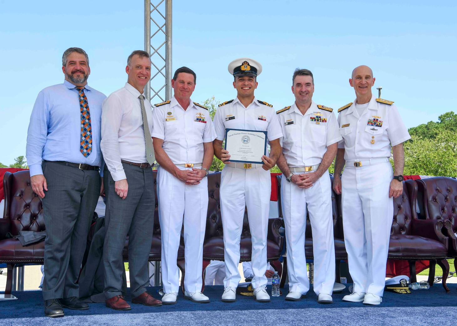 Adm. James F. Caldwell Jr., director, Naval Nuclear Propulsion Program, right, Royal Australian Navy Vice Adm. Jonathan Mead, director-general of the Australian Submarine Agency, Royal Australian Navy Lt. Cmdr James Heydon, Royal Australian Navy Vice Adm. Mark Hammond, Chief of Navy, the Honorable Erik Raven, Under Secretary of the Navy, and Abraham M. Denmark, Senior Advisor to the Secretary of Defense for AUKUS, pose for a photo during a United States Naval Nuclear Power School (NPS) graduation ceremony at Naval Nuclear Power Training Command (NNPTC), July 7, 2023. Three Royal Australian Navy (RAN) officers graduated NPS, marking a significant step in Australia's goal to operate conventionally-armed, nuclear-powered attack submarines (SSNs). (U.S. Navy photo by Mass Communication Specialist 2nd Class Dart D. De La Garza)