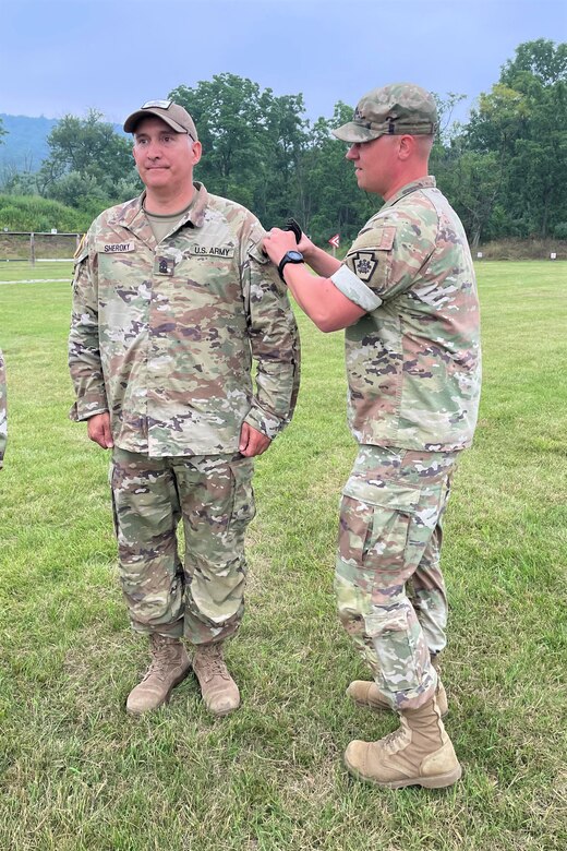 Overall first-place finisher 1st Sgt. Scott Sheroky, left, of the Eastern Army National Guard Aviation Training Site, receives his Governor's Twenty uniform tab from Capt. Shawn Garghill, chief of the Pennsylvania Army National Guard Individual Training Branch, at the conclusion of the annual Governor’s Twenty marksmanship competition July 1, 2023, at Fort Indiantown Gap, Pa. (Courtesy photo)