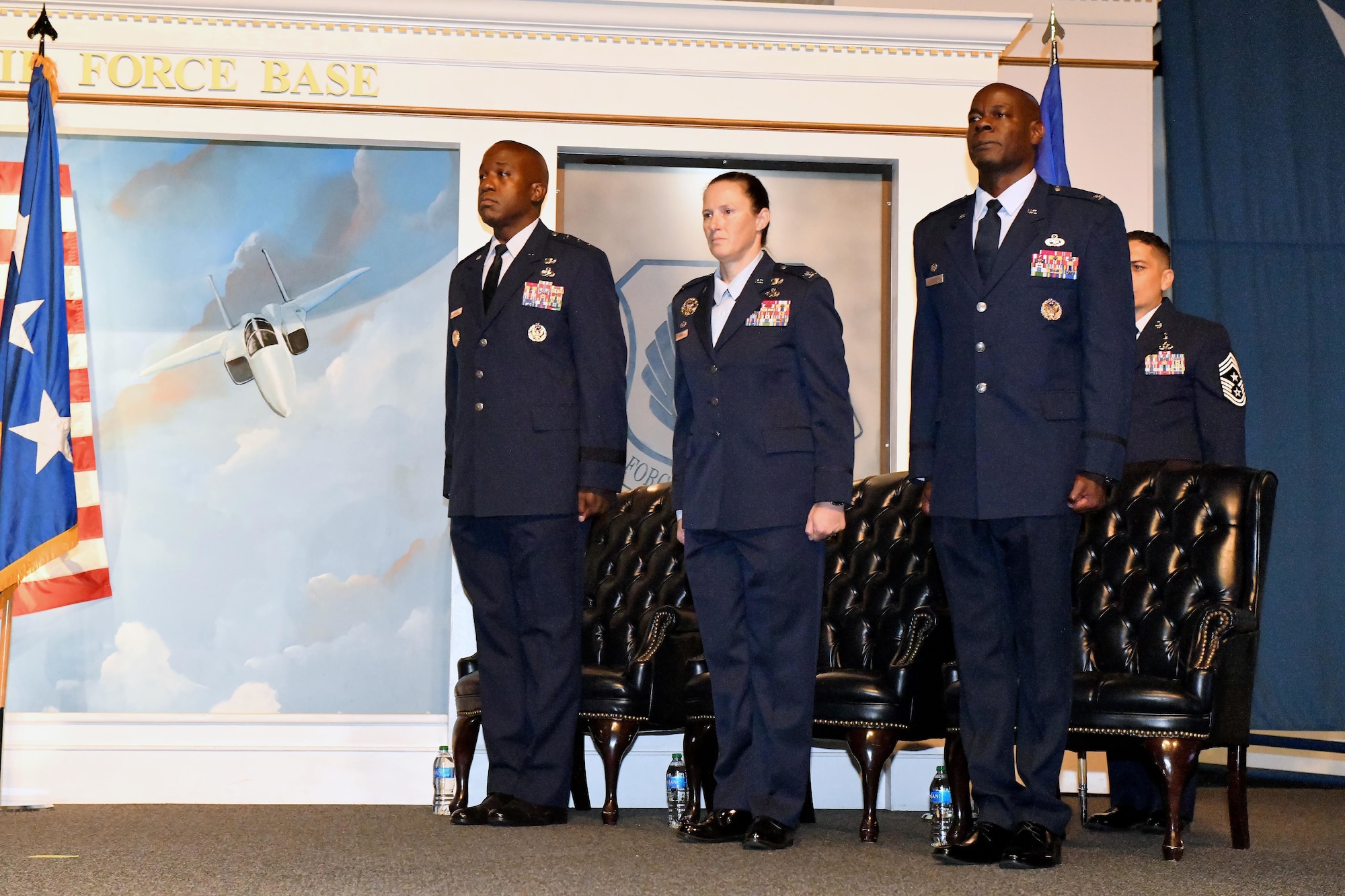 Three people standing at attention