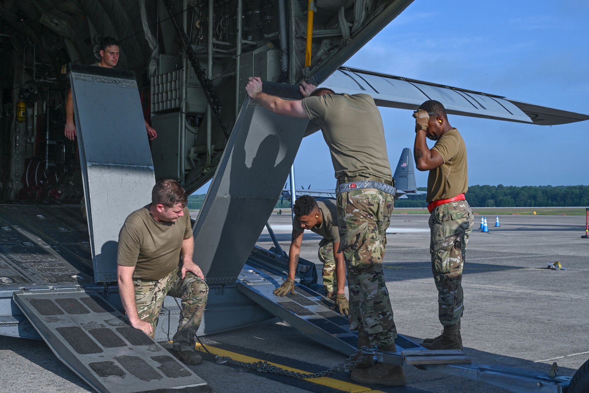 Airmen load onto a C-130J Super Hercules to head to an exercise