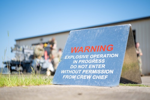 A warning sign is placed around the perimeter of the explosive operation.