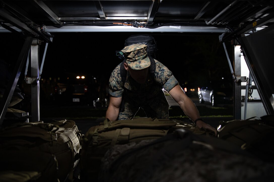 U.S. Marine Corps Maj. Zachary Isberner, financial manager, 2d Marine Expeditionary Brigade (2d MEB), loads luggage onto a bus to the airport from Marine Corps Base Camp Lejeune, on May 29, 2023. 2d MEB Marines head to Naples, Italy, for a deployment Task Force 61/2. (U.S. Marine Corps photo by Lance Cpl. Jack Labrador)