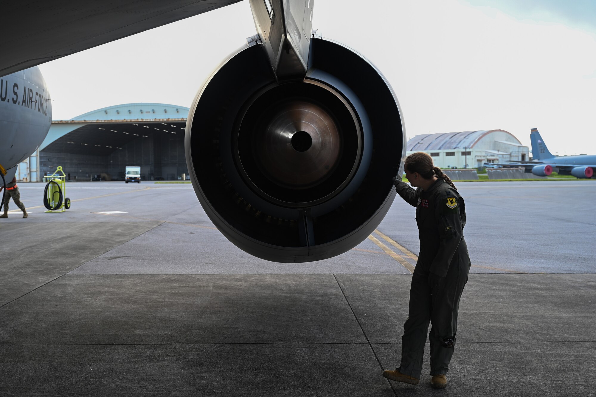 An Airman inspects an aircraft engine.
